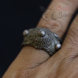 Decorative tribal ring displayed with side floral wings and raised crown structure