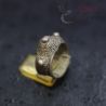 Side angle of ethnic crown-shaped ring highlighting floral wing and granulated knob details