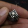 vintage shan lisu hill tribe silver ring worn on finger closeup floral rosette