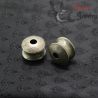 Close-up top side angle view of silver ear plug from Burma worn by Yinbao Karen, showing detailed craftsmanship and patina