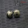 Vintage silver ear plug from Shan State, Burma, displayed from top side angle highlighting tribal design."