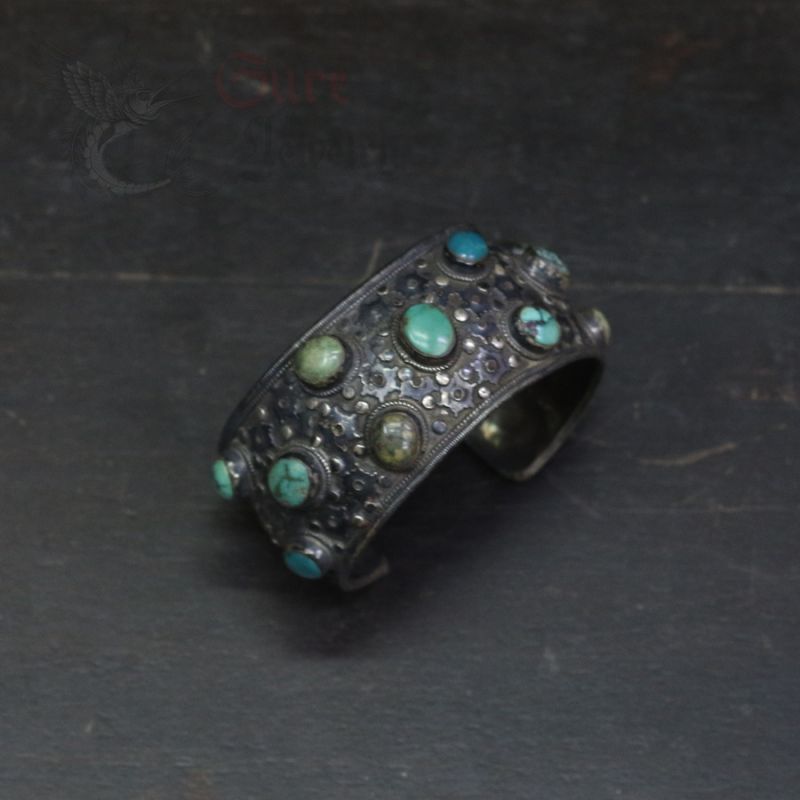 Top view of handcrafted Nepal silver bangle with turquoise stone setting on top Top view of handcrafted Nepal silver bangle with turquoise stone setting on top