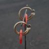 Antique Yao silver earrings with red glass circles – hanging display angled view
