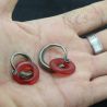Antique Yao silver earrings with red glass circles – in hand close-up view