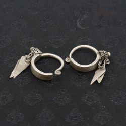 TOP SIDE ANGLE-5: Antique silver Yao earrings with floral finials and leaf pendants, top side view.