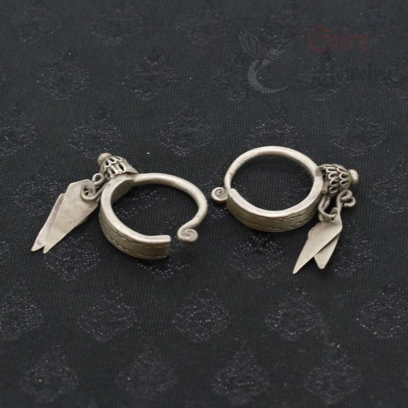 TOP SIDE ANGLE-5: Antique silver Yao earrings with floral finials and leaf pendants, top side view.