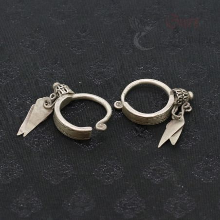 TOP SIDE ANGLE-5: Antique silver Yao earrings with floral finials and leaf pendants, top side view.
