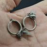 IN HAND SIDE ANGLE-4: Antique Yao silver earrings with leaf-shaped pendants shown in hand, side angle.