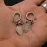 IN HAND:
ANTIQUE YAO EARRINGS HELD IN HAND TO SHOW SCALE AND DETAIL, ENGRAVED LEAF SHAPE AND CURVED HOOK DESIGN