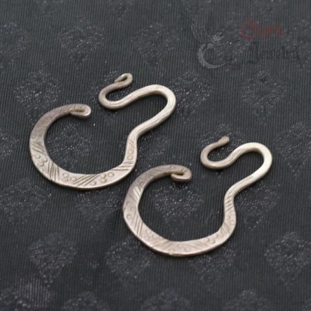 Antique Yao silver earrings top and side angle showing engraved geometric design and curved hook shape.