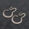 Antique Yao silver earrings top and side angle showing engraved geometric design and curved hook shape.