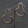 Antique Yao silver earrings hanging on display showing elegant curve and antique finish.