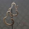 Antique Yao silver earrings on hanging display showing craftsmanship and cultural detail.