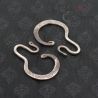 Antique Yao silver earrings angled close-up emphasizing engraved geometric motifs.