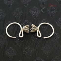 TOP SIDE ANGLE-1: Top view showing bent round floral design of Lahu tribe silver earrings.