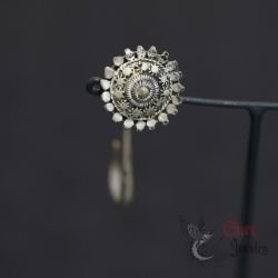 silver tribal floral earring on hanging display