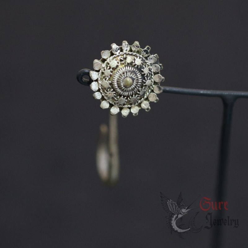 silver tribal floral earring on hanging display