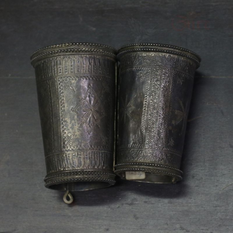 alt: "Antique Afghan silver bracelets pair – engraved tribal cuffs top view"