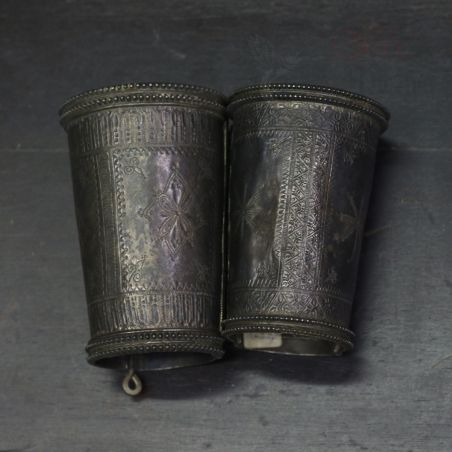 alt: "Antique Afghan silver bracelets pair – engraved tribal cuffs top view"
