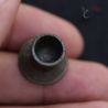 Ethnographic ear plug in hand close-up of rim and surface