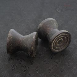 Antique Dayak ironwood ear plugs pair Borneo tribal jewelry top side angle 1