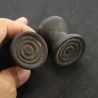 Antique Dayak ironwood ear plugs shown in hand side angle 2