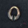 Khmer-period bronze omega ear ornament, close view of curved profile and surface wear with remaining gilding
