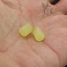 in hand SIDE ANGLE-2: In-hand side angle of Burmese glass ear spools with translucent yellow-green tone