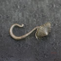 TOP SIDE ANGLE-2: Traditional long hook earring with flower terminal, top and side angle showing curved hook and aged patina