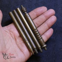 Antique brass Sak Yant tattoo tapper shown in hand for size and craftsmanship reference
