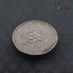 Antique Shan Akha tribal silver ear plug top side angle with repoussé floral design from Golden Triangle region