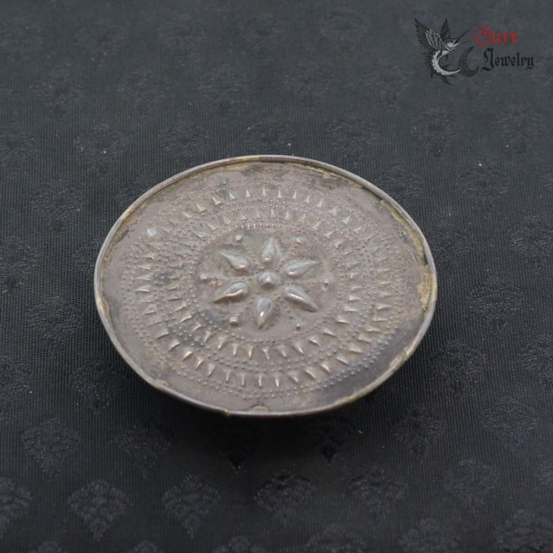 Antique Shan Akha tribal silver ear plug top side angle with repoussé floral design from Golden Triangle region