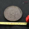 Antique tribal silver ear plug measured with ruler showing 70mm diameter size