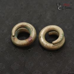 Ta Oy copper alloy spiral ear ornaments pair top view from Vietnam Laos border region
