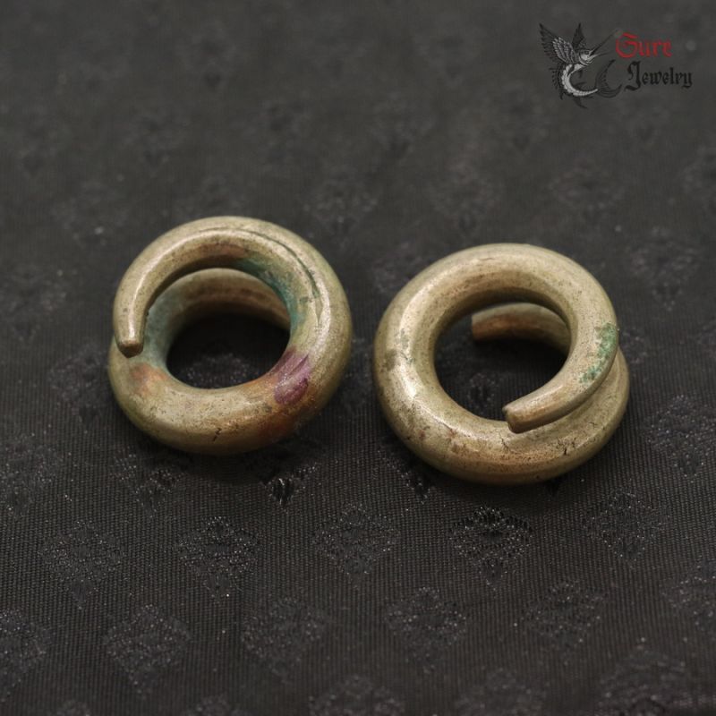 Ta Oy copper alloy spiral ear ornaments pair top view from Vietnam Laos border region
