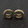 Traditional Ta Oy spiral ear ornaments pair overhead view Southeast Asia