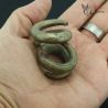 Ta Oy spiral ear ornaments pair wearable tribal jewelry in hand