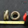 Traditional tribal ear weights with ruler for size reference